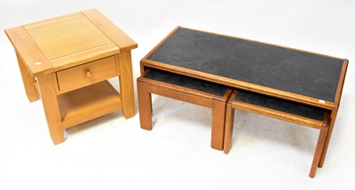 Lot 14 - A mid-20th century long nest of three tables...