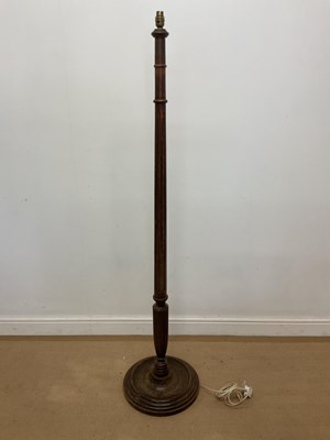 Lot 343 - An oak column standard lamp on a circular base,...