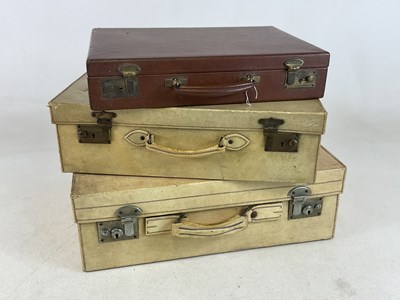 Lot 48 - Two vellum suitcases and a brown leather case,...
