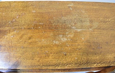 Lot 53 - A modern oak circular drop-leaf table raised...