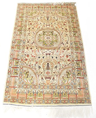 Lot 115A - A Persian silk/wool blend cream ground carpet...