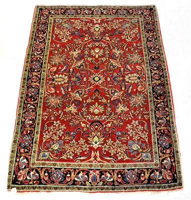 Lot 116A - A woollen hand knotted red ground carpet with...