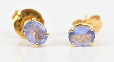 Lot 184 - A pair of yellow metal blue topaz ear studs,...