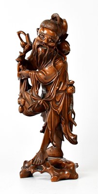 Lot 381 - A Japanese carved wooden figure of a man with...