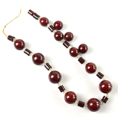Lot 562 - An Art Deco style cherry amber coloured beaded...