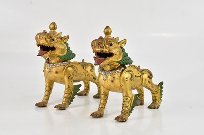 Lot 1540 - A pair of Chinese patinated bronze models of...