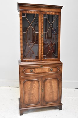 Lot 1062 - A reproduction mahogany secretaire bookcase,...