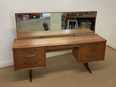 Lot 380 - AUSTINSUITE; a 1960s teak dressing table, with...
