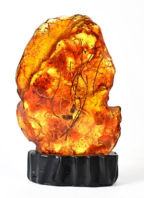 Lot 500 - An amber-coloured slab suspended with insects...