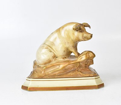 Lot 215 - A porcelain blush ware model of a pig seated...