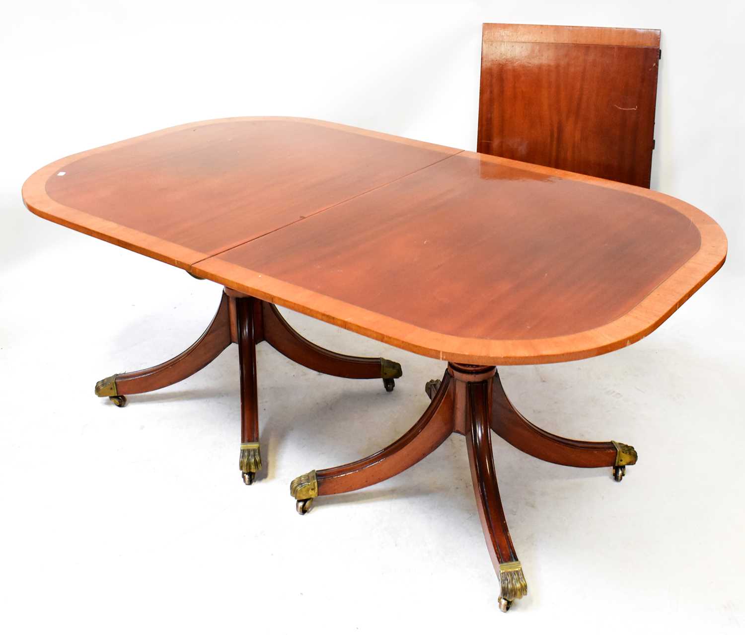 Lot 30 - A Regency-style mahogany crossbanded twin...
