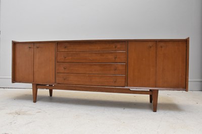 Lot 5 - A mid century teak sideboard with four central...