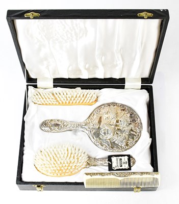 Lot 691 - A hallmarked silver four-piece dressing table...
