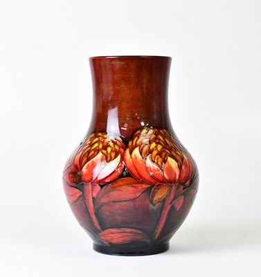 Lot 295 - MOORCROFT; a red ground 'Waratah' pattern vase...