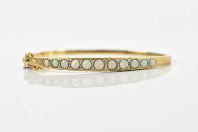 Lot 31 - A yellow metal opal and diamond set hinged...
