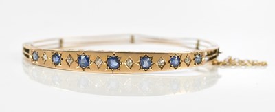 Lot 32 - A Victorian yellow metal hinged bangle,...