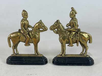 Lot 124 - A pair of brass and cast doorstops in the form...