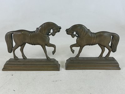 Lot 125 - An opposing pair of brass doorstops in the...