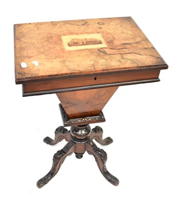 Lot 75 - A Victorian walnut sewing table, the top with...