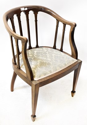 Lot 62 - An Edwardian mahogany tub chair on square...