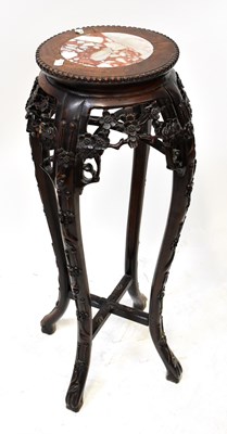 Lot 397 - An Oriental carved wooden jardinière stand...