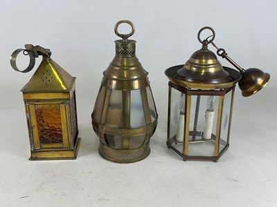 Lot 337 - Three brass and glass lanterns, height 41cm.