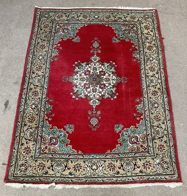 Lot 244 - A large Eastern style red ground rug, with...