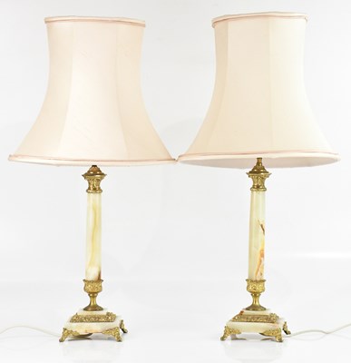 Lot 626 - A pair of brass mounted onyx table lamps,...