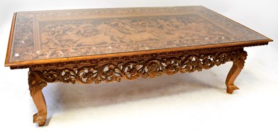 Lot 336 - A large profusely carved coffee table with...