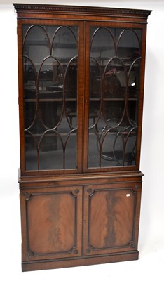Lot 28 - A Georgian-style mahogany glazed bookcase with...