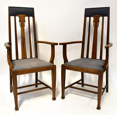 Lot 66 - A pair of Arts & Crafts oak open arm elbow...