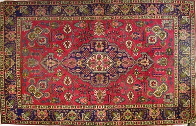Lot 117 - A large hand-knotted Iranian Tabriz red ground...