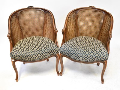 Lot 31 - A pair of French Louis XV style bergère tub...