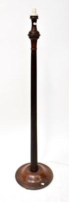 Lot 132 - A mahogany standard lamp with a turned and...