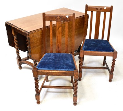 Lot 43 - A 1930s oak drop-leaf gate leg dining table...