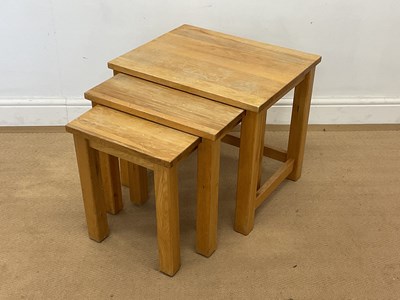 Lot 440 - A modern nest of three oak tables, height 45cm,...