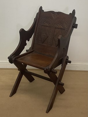 Lot 382 - A carved oak Glastonbury chair, height 98cm.