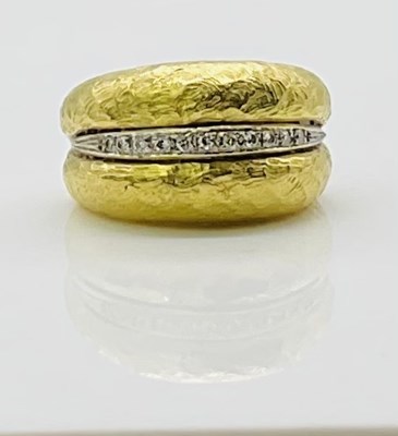 Lot 720 - An 18ct textured yellow gold diamond set ring,...