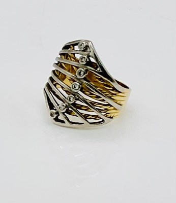 Lot 723 - An 18ct white and yellow gold ring, set with...