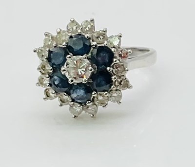 Lot 730 - An 18ct white gold sapphire and diamond...