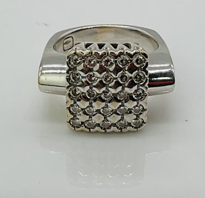 Lot 733 - An 18ct white gold and pavé diamond set ring...