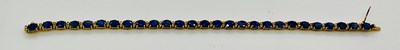 Lot 735 - A 14ct yellow gold synthetic sapphire and...