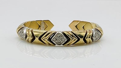 Lot 736 - A 9ct yellow gold slightly sprung bangle, with...