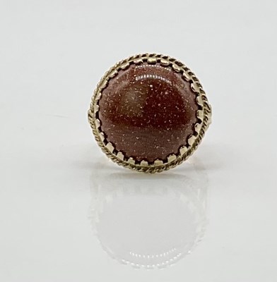 Lot 741 - A 9ct yellow gold 'goldstone' domed cabochon...