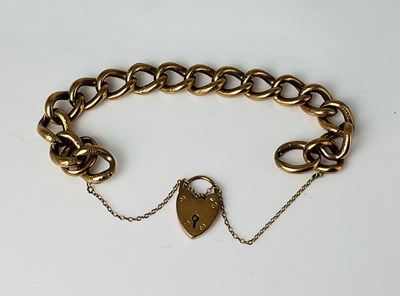 Lot 754 - A 9ct gold hollow link bracelet with padlock...
