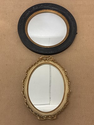 Lot 426 - A black painted circular convex wall mirror,...