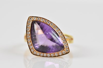 Lot 2527 - An 18ct yellow gold dress ring, set with an...