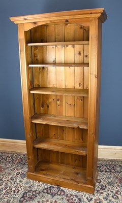 Lot 3063 - A modern pine bookcase, with five shelves, on...