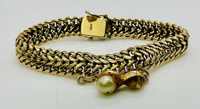 Lot 763 - An 18ct yellow gold bracelet, with pearl set...