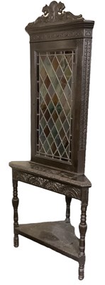 Lot 38 - A 19th century carved oak corner cupboard on...